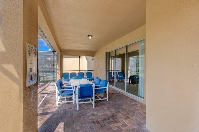 view of patio / terrace featuring a lanai and outdoor dining space