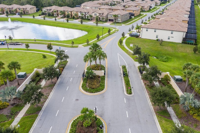 drone / aerial view with a residential view and a water view