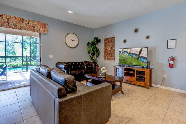 8804 Macapa Dr, Kissimmee, FL 34747 - living room with light tile patterned floors and recessed lighting