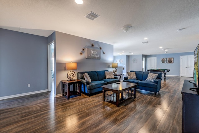 living room with a textured ceiling, dark hardwood / wood-style floors, pool table, and a wealth of natural light