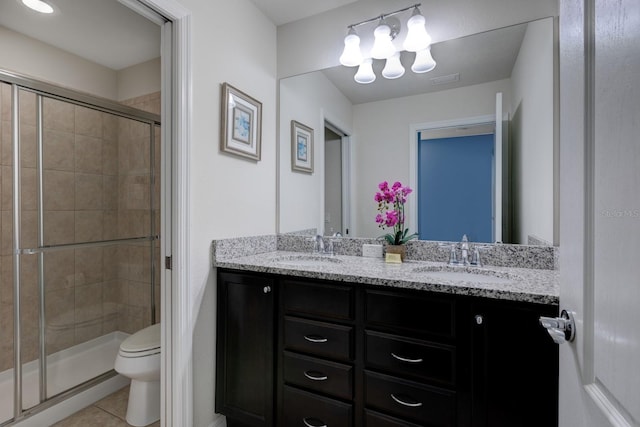 bathroom featuring walk in shower, vanity, toilet, and tile patterned floors