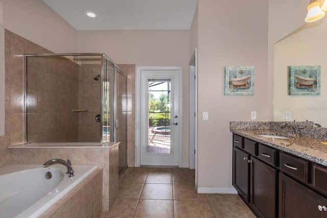 bathroom with tile patterned floors, a shower stall, vanity, and a garden tub