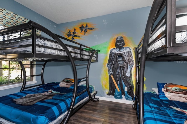 bedroom featuring a textured ceiling and dark wood-type flooring