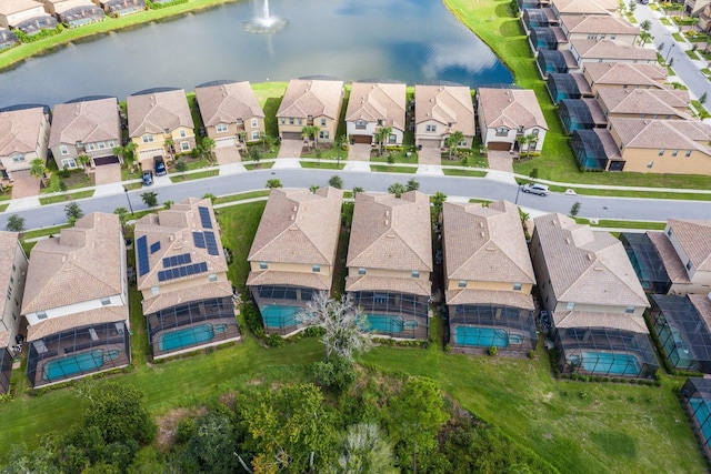 drone / aerial view with a residential view and a water view