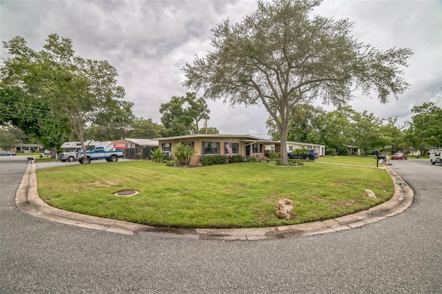 ranch-style home with a front lawn