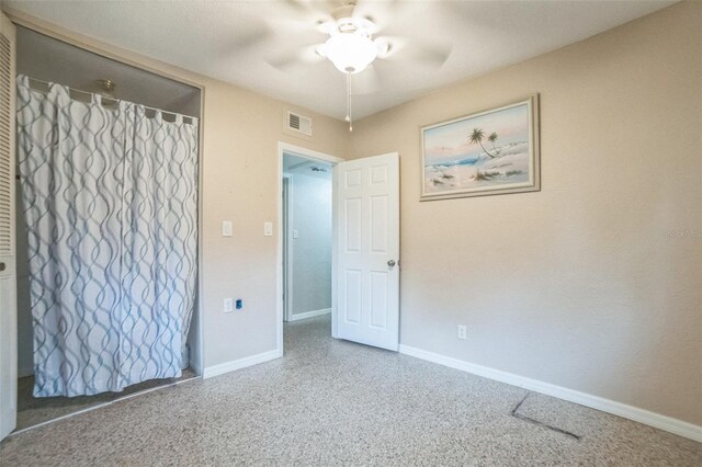 interior space with ceiling fan