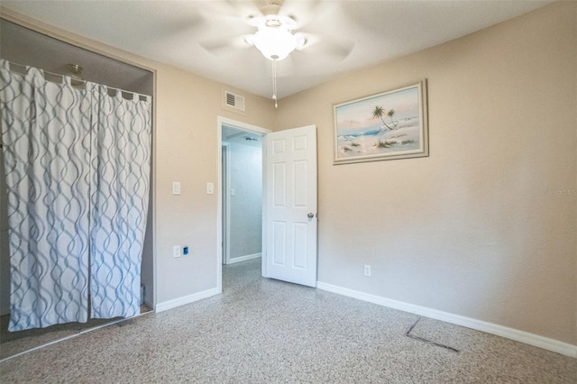 interior space with ceiling fan