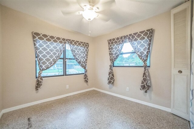 unfurnished room featuring a textured ceiling and ceiling fan