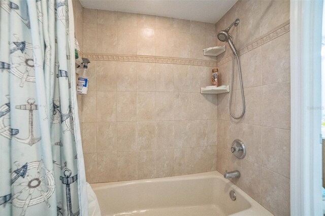 bathroom with shower / bath combo with shower curtain