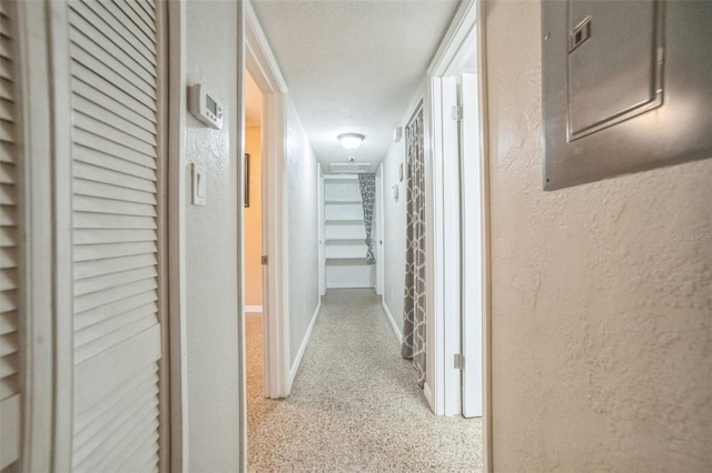 hallway with a textured ceiling