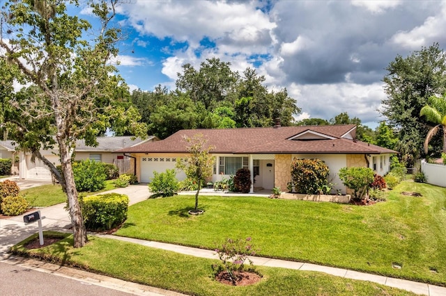 ranch-style home with a front yard and a garage