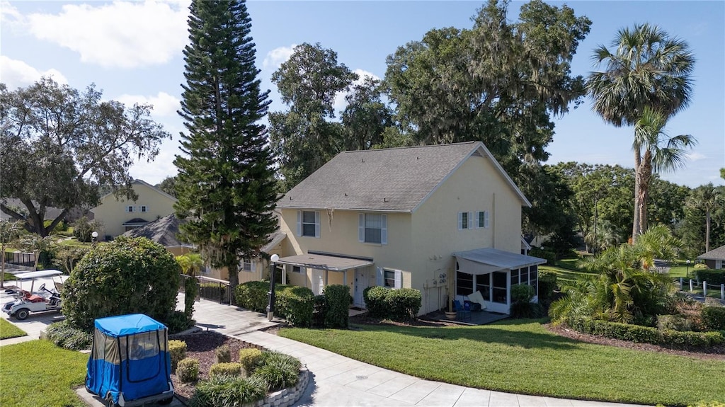 view of front of home featuring a front lawn and stucco siding