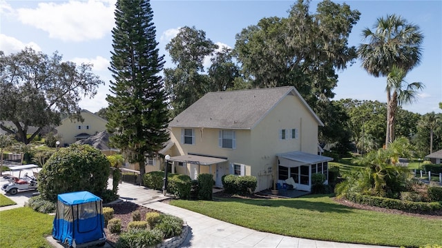 view of front of home featuring a front lawn and stucco siding