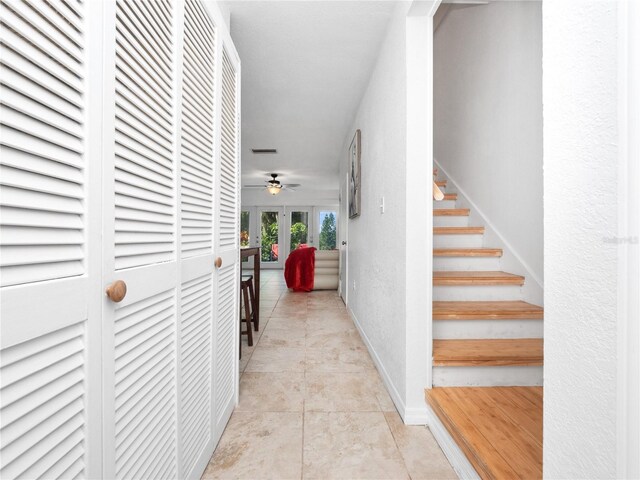 hall with light tile patterned floors