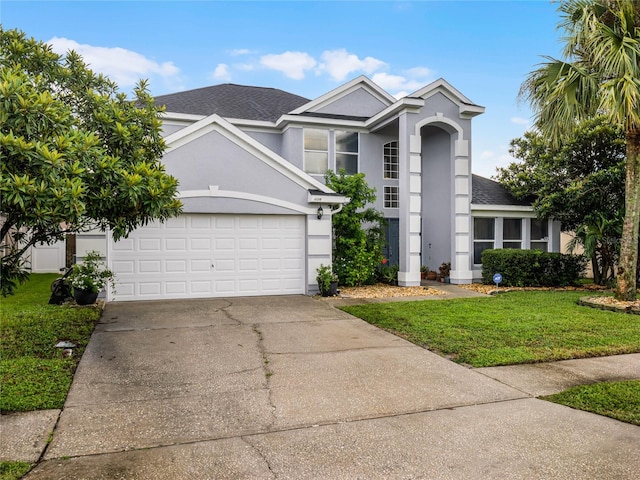 view of front property with a garage and a front lawn