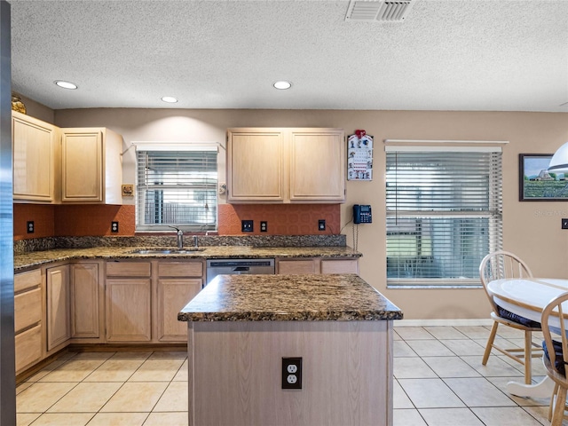 kitchen with backsplash, a center island, light brown cabinets, and sink