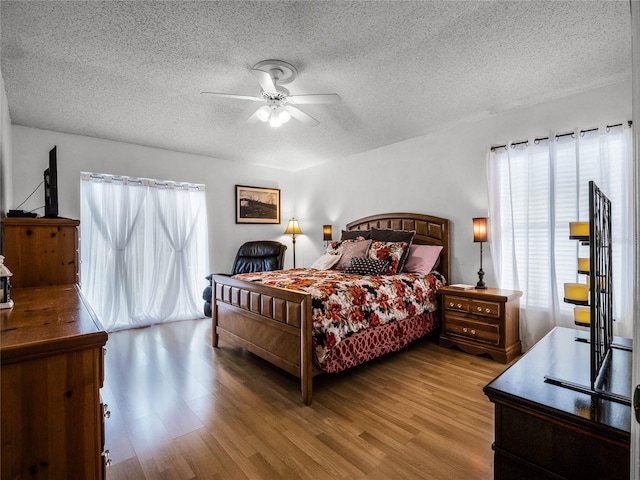 bedroom featuring ceiling fan, a textured ceiling, and hardwood / wood-style floors