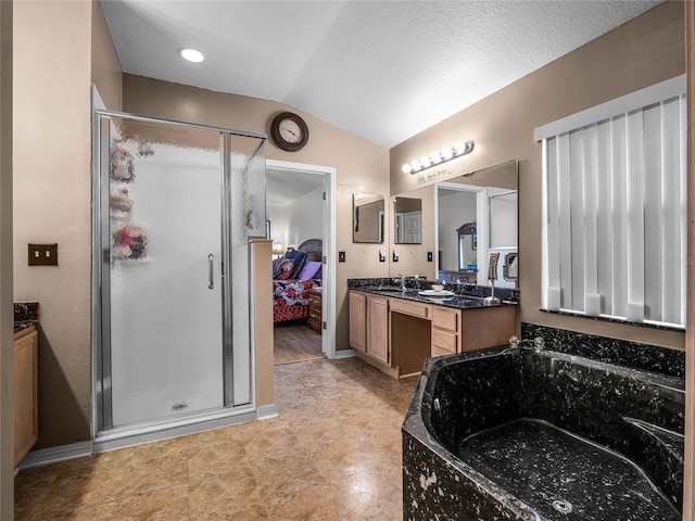 bathroom featuring independent shower and bath, vanity, vaulted ceiling, and a textured ceiling