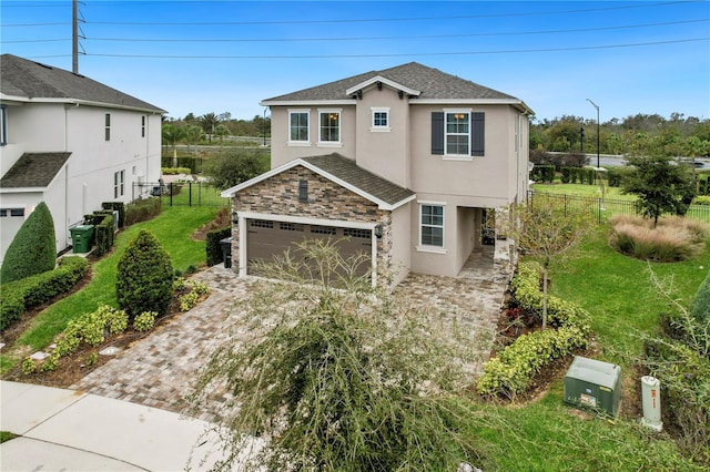 view of front of home featuring a garage and a front yard