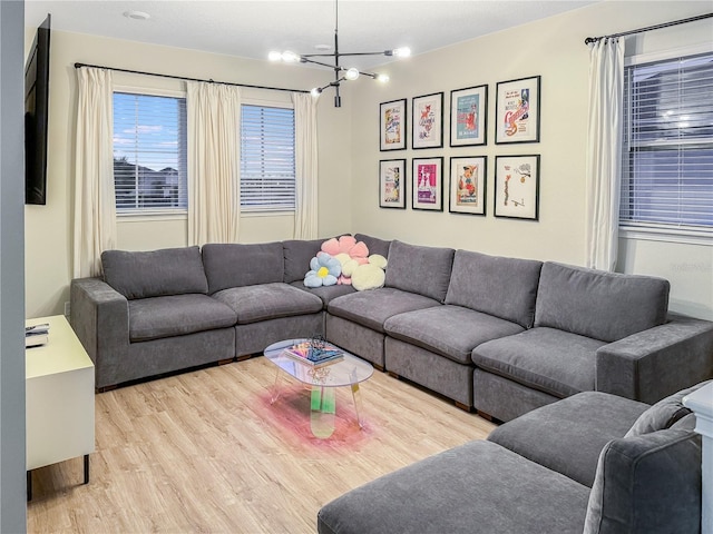 living room with a chandelier and light hardwood / wood-style floors