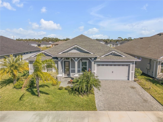 view of front facade with a front yard and a garage