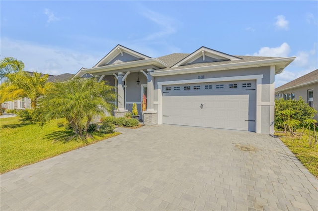 view of front of property with a garage and a front lawn