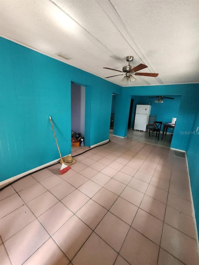 interior space with a textured ceiling and ceiling fan