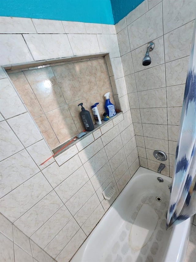 bathroom with shower / bathtub combination with curtain