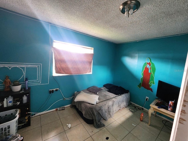 bedroom featuring a textured ceiling and light tile patterned floors