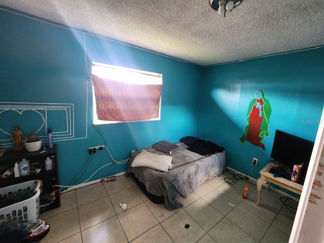 interior space with light tile patterned floors and a textured ceiling