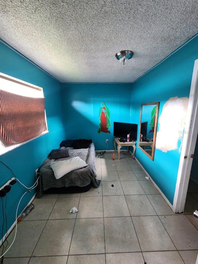 unfurnished bedroom featuring a textured ceiling and tile patterned floors