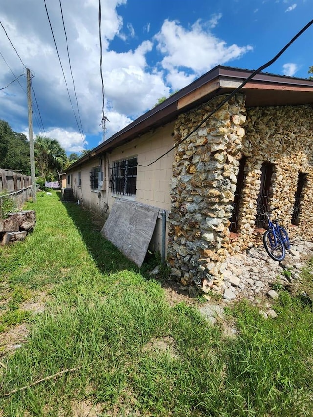 view of side of property with a yard