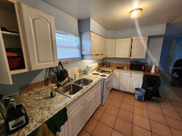 kitchen with white electric range, light stone countertops, light tile patterned floors, and sink