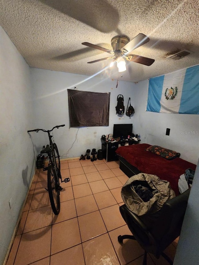 interior space with ceiling fan and a textured ceiling