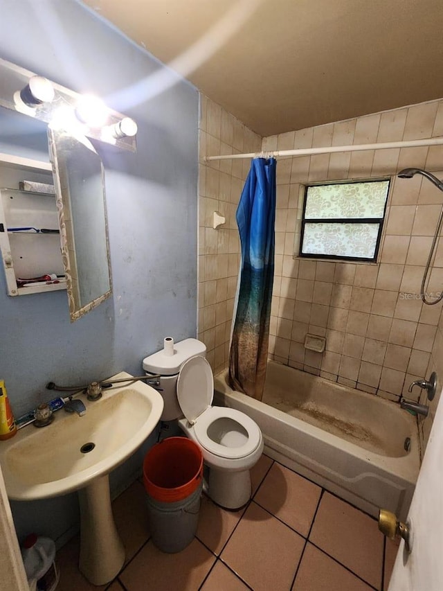 bathroom featuring tile patterned floors, toilet, and shower / bathtub combination with curtain