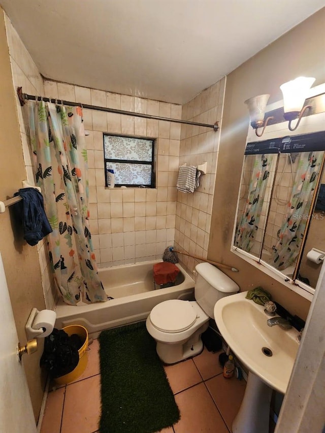 full bathroom with tile patterned flooring, toilet, sink, and shower / bathtub combination with curtain