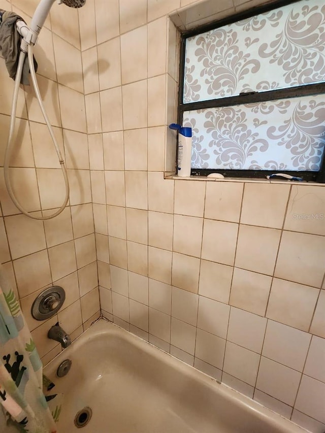 bathroom with shower / bath combination with curtain