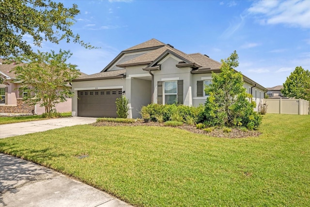 view of front facade with a garage and a front lawn