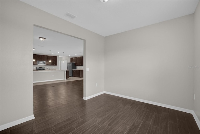 8064 Olive Brook Dr, Wesley Chapel, FL 33545 - empty room with dark wood-style floors, visible vents, and baseboards