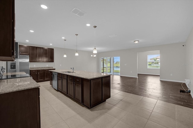 8064 Olive Brook Dr, Wesley Chapel, FL 33545 - kitchen featuring visible vents, dark brown cabinets, stainless steel appliances, and a sink