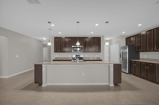 8064 Olive Brook Dr, Wesley Chapel, FL 33545 - kitchen featuring dark brown cabinets, stainless steel appliances, an island with sink, and a sink