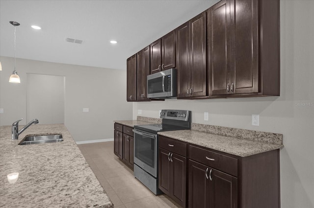 8064 Olive Brook Dr, Wesley Chapel, FL 33545 - kitchen with light countertops, dark brown cabinets, appliances with stainless steel finishes, and a sink