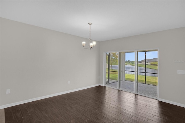 8064 Olive Brook Dr, Wesley Chapel, FL 33545 - empty room featuring baseboards, an inviting chandelier, and dark wood-style floors