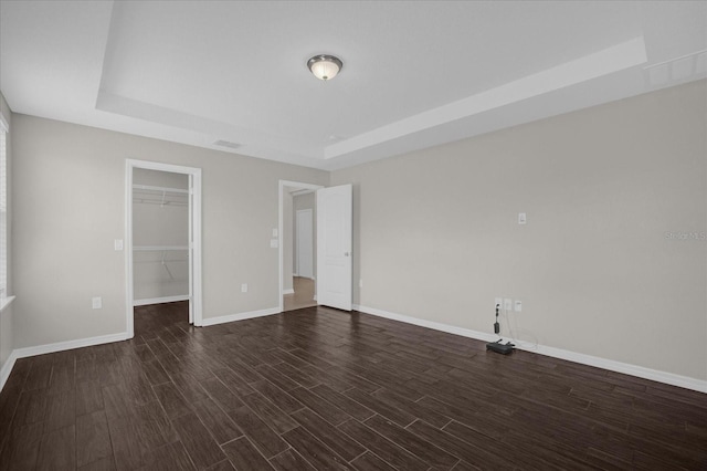 8064 Olive Brook Dr, Wesley Chapel, FL 33545 - interior space with baseboards, a raised ceiling, visible vents, and dark wood-style flooring