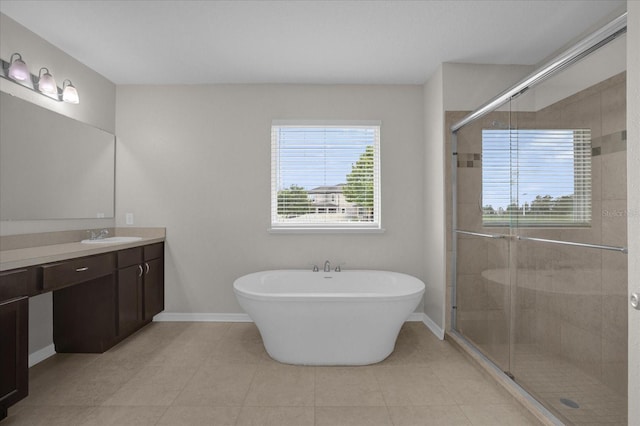 8064 Olive Brook Dr, Wesley Chapel, FL 33545 - full bath with tile patterned floors, a stall shower, baseboards, a soaking tub, and vanity