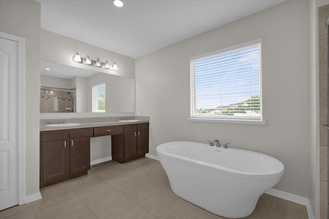 8064 Olive Brook Dr, Wesley Chapel, FL 33545 - full bathroom with double vanity, a shower stall, a freestanding bath, and a sink