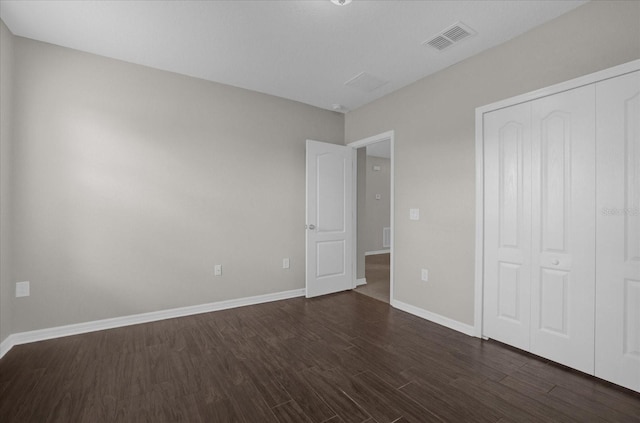 8064 Olive Brook Dr, Wesley Chapel, FL 33545 - unfurnished bedroom with a closet, baseboards, visible vents, and dark wood-style flooring
