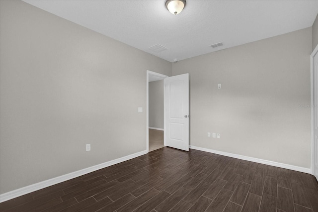 8064 Olive Brook Dr, Wesley Chapel, FL 33545 - spare room featuring visible vents, baseboards, and dark wood-style flooring