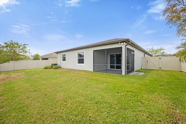 8064 Olive Brook Dr, Wesley Chapel, FL 33545 - rear view of property featuring a sunroom, a gate, a lawn, and a fenced backyard