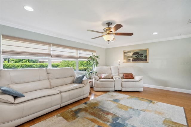 living room featuring light wood-type flooring, ornamental molding, and ceiling fan